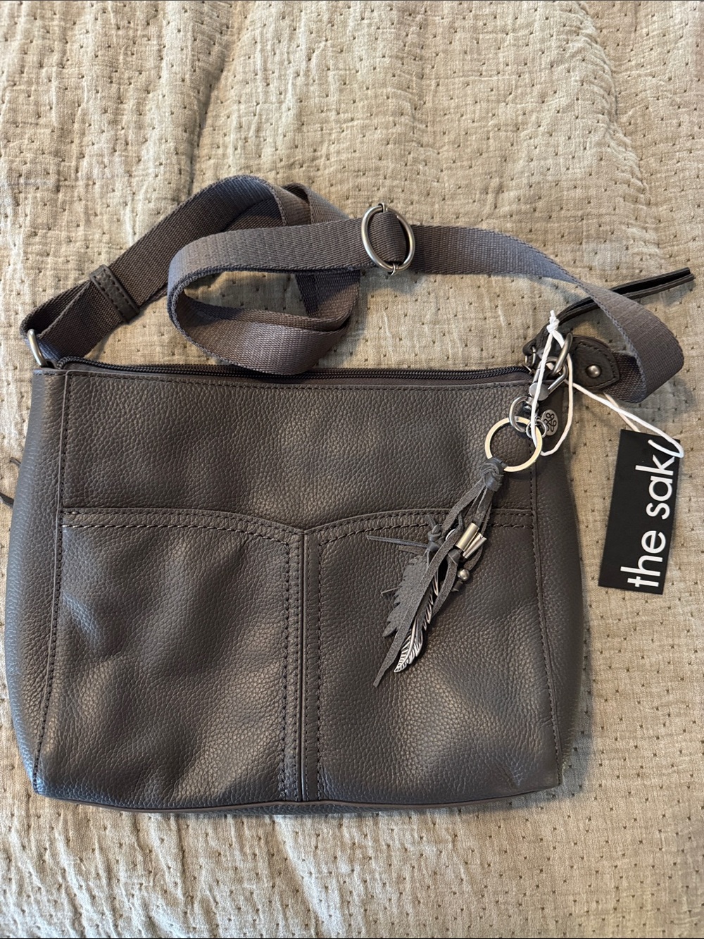The Sak Dark Gray Leather Crossbody with Feather Charm